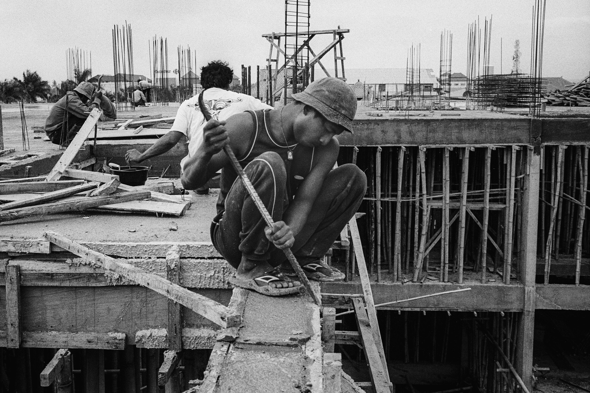  Kerobokan, Indonesia  Labourer removing cement supports. 