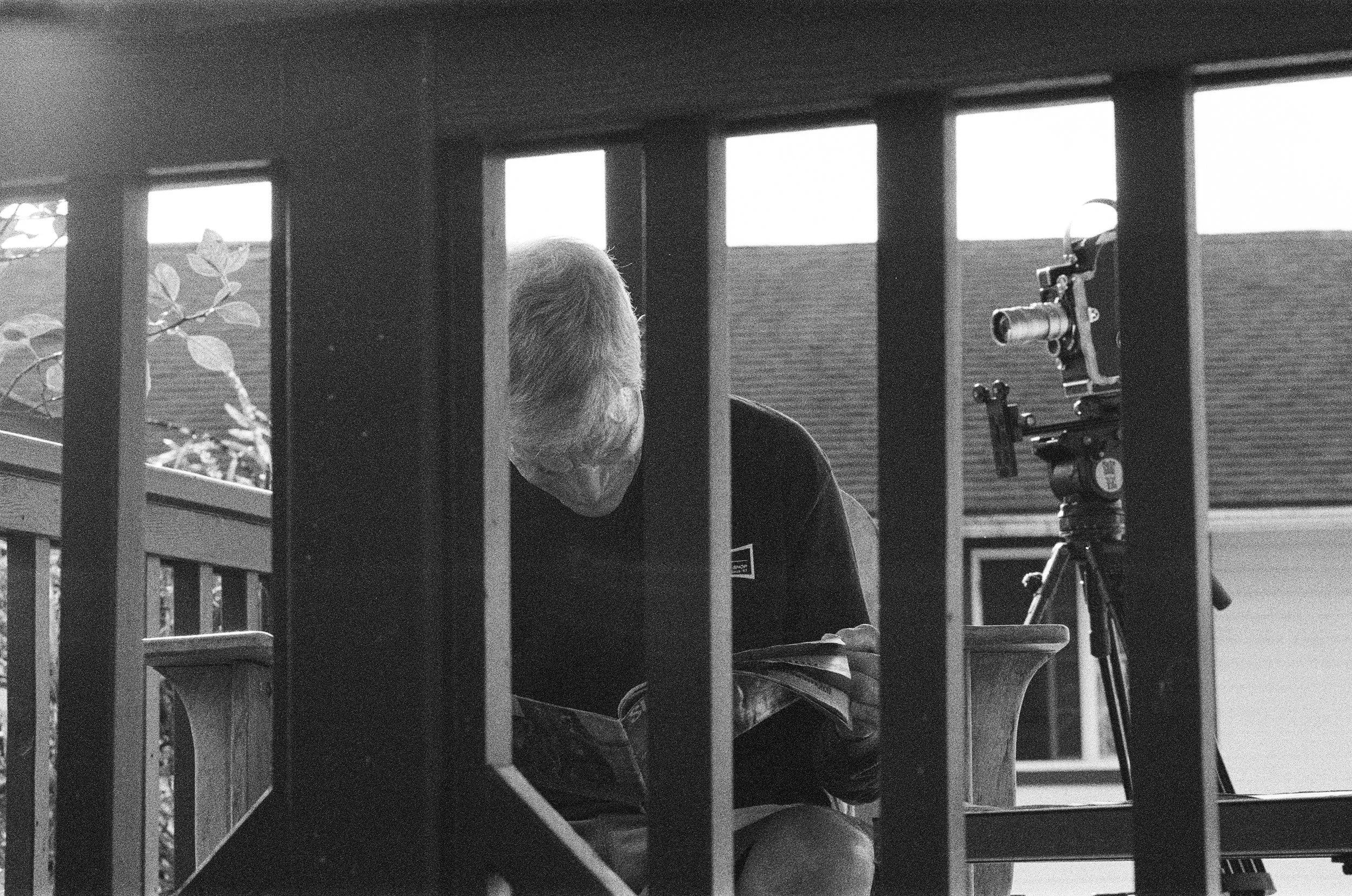 Jock Sutherland looking through old Surfer magazines