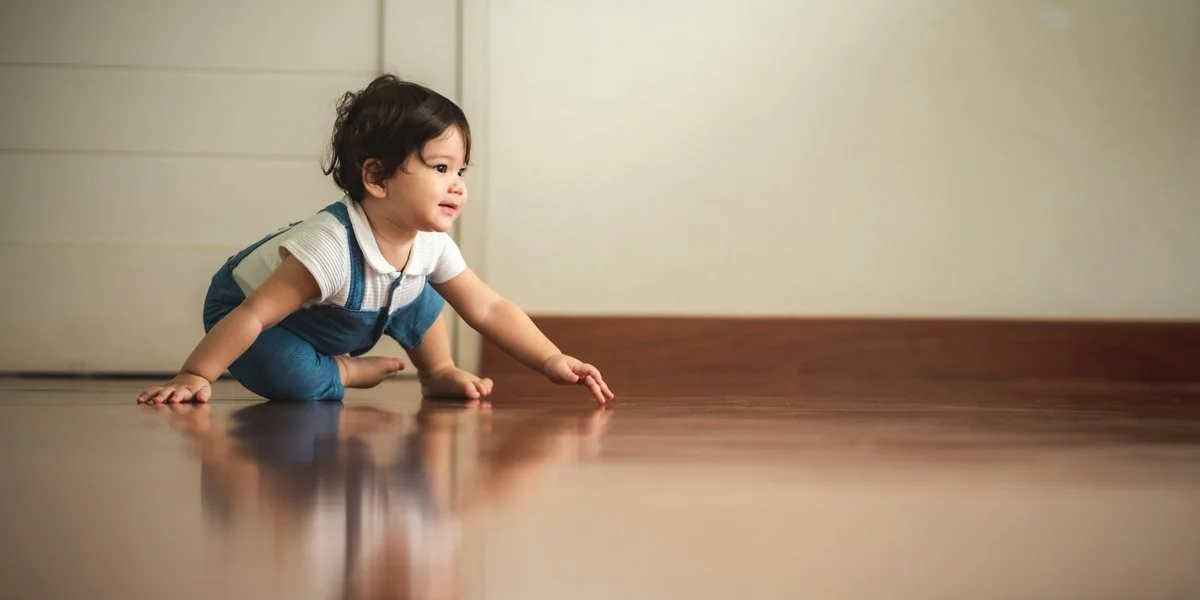 Baby practicing crawling movement and coordination during developmental milestone stage