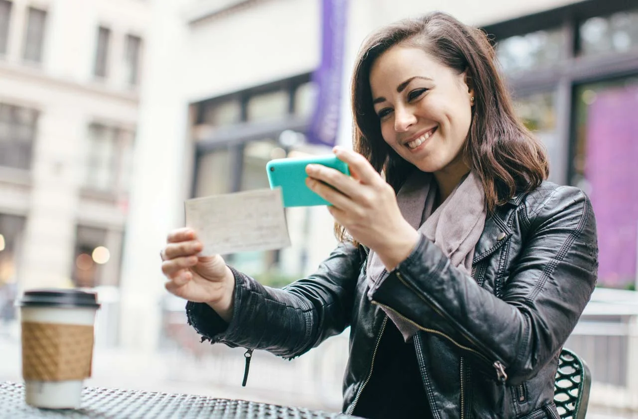 Girl Taking picture of check.jpg