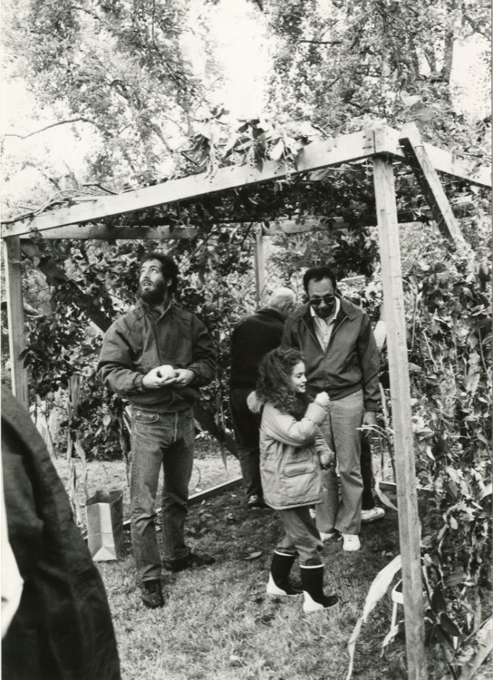 Men and girl standing in a sukkah