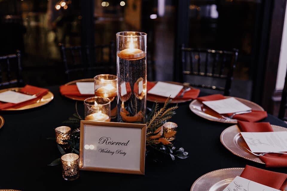 Candles are an easy way to fill your table without that large price tag. Gold floating candles and rust colored napkins completed this look!