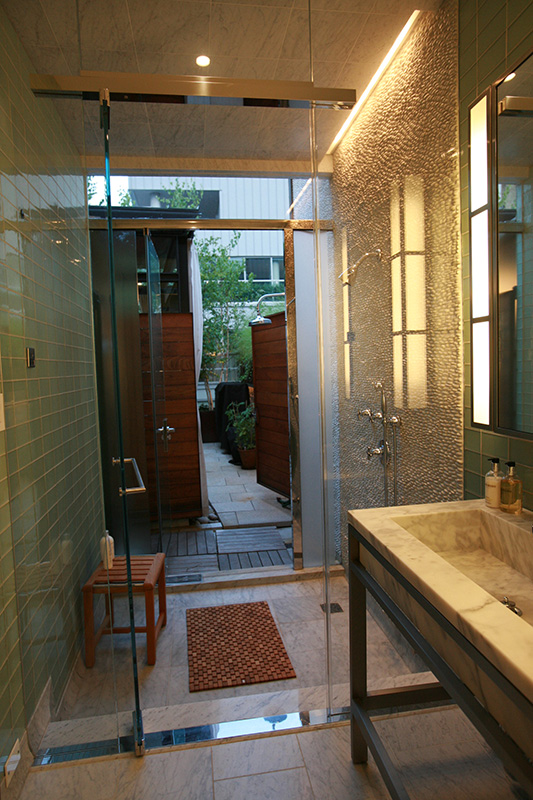 Penthouse bathroom with indoor and outdoor showers