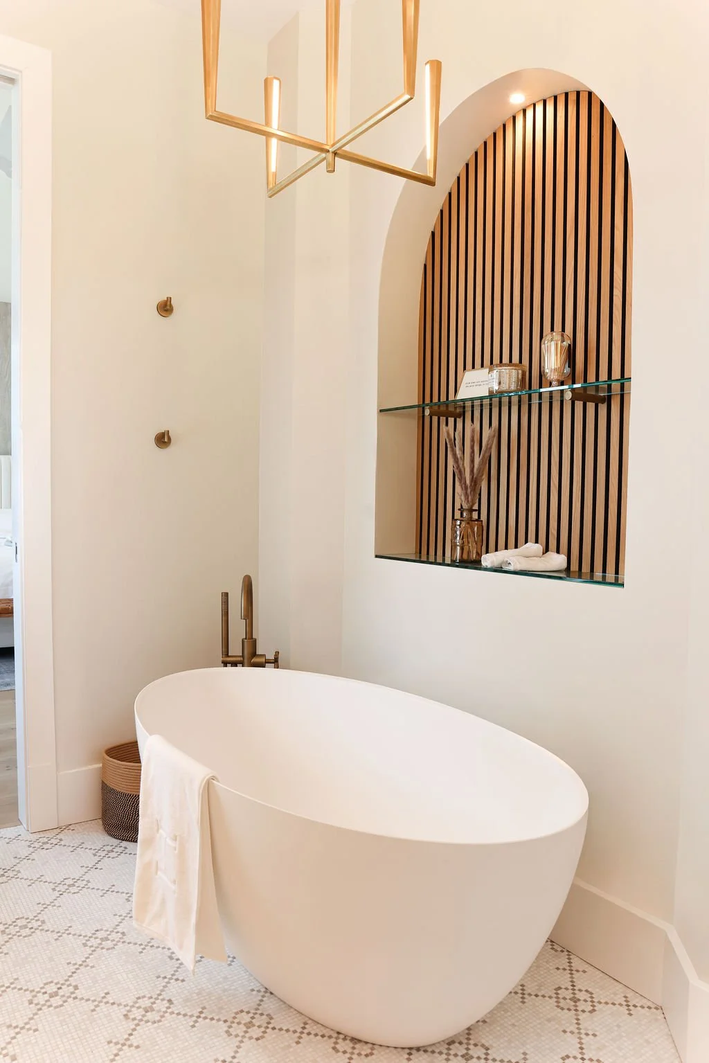 Freestanding tub and chandlier by visual comfort