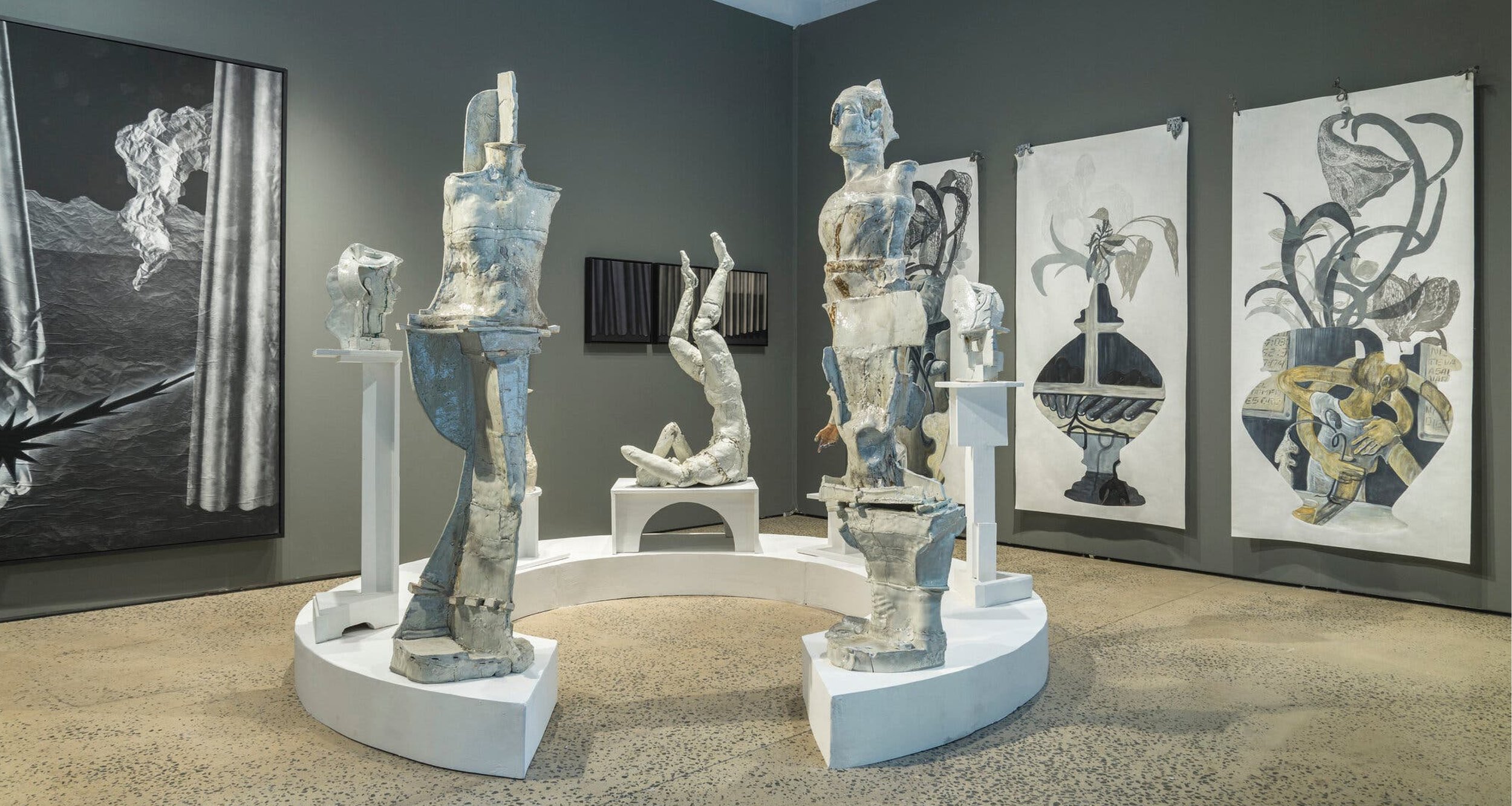  Installation view of Trotter &amp; Sholer and Swivel Gallery exhibition room. Porcelain sculptures are by Derek Weisberg, foreground. At left, curtain collage by Pajtim Osmanaj; right, oil pastels by Luján Pérez. 