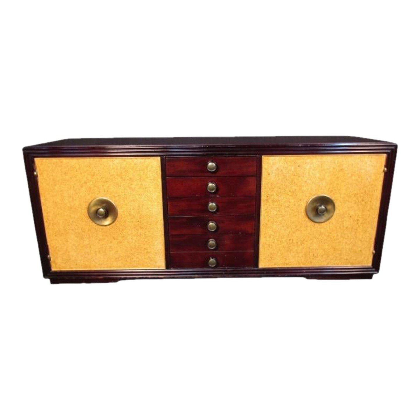 Mid Century Credenza in The Manner of Paul Frankl

Mid Century credenza in the Manner of Paul Frankl featuring mahogany veneer, cork laminated doors and brass hardware. inside the left door holds 4 dovetail jointed drawers, right door contains 2 shel