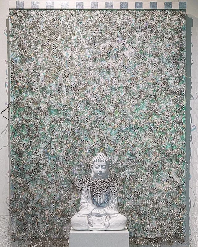 White Noise, Acrylic, pop can tabs, glitter, iridized ribbons, tarp on canvas with Buddha figure collaged fabric, tarp, Swarovski crystals on white stand.  49 X 36 X 4&rdquo;, 2019
#mixedmediaartist #nbartists #modernartists #womenartists #womenartistsofinstagram #canadianartists #artnxtlevel2019 #contemporary_art #contemporaryartists