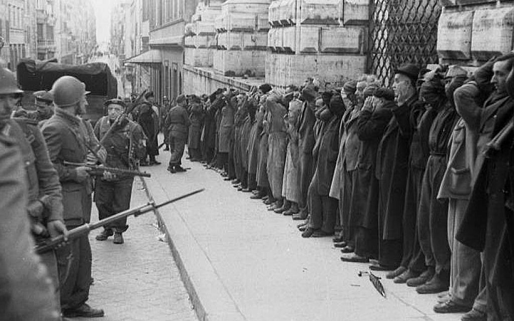 Italian civilians are arrested in Rome by German soldiers following a partisan attack on Nazi forces during World War II.
