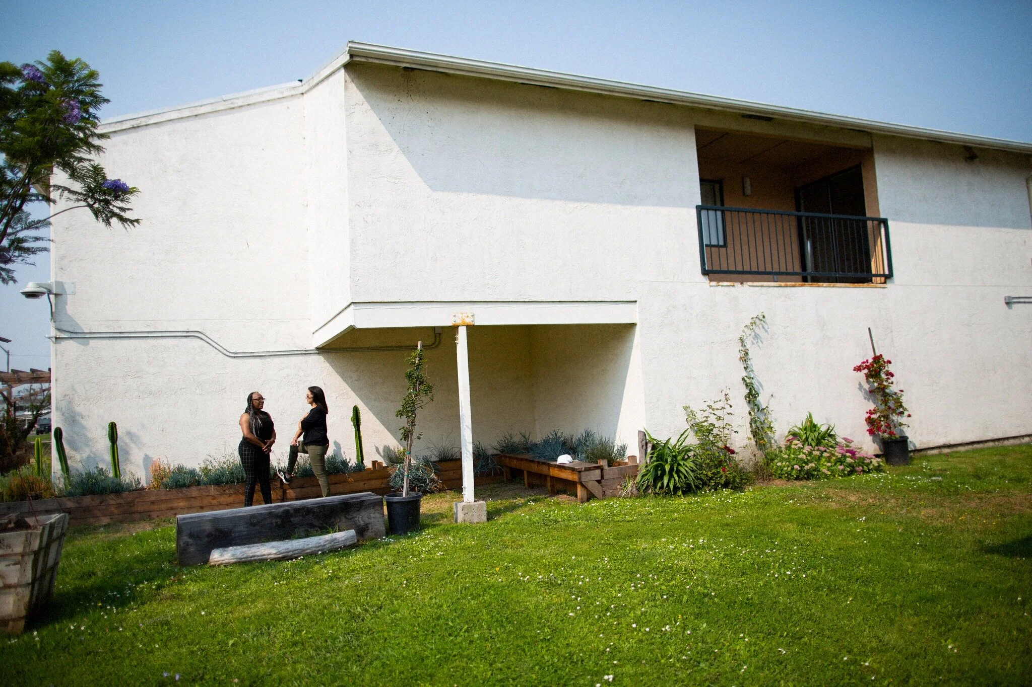 Cooper Garvin (left) and Schwartz (right), outside the apartment building on Treasure Island, renovated naval housing. Credit: Talia Herman for The New York Times