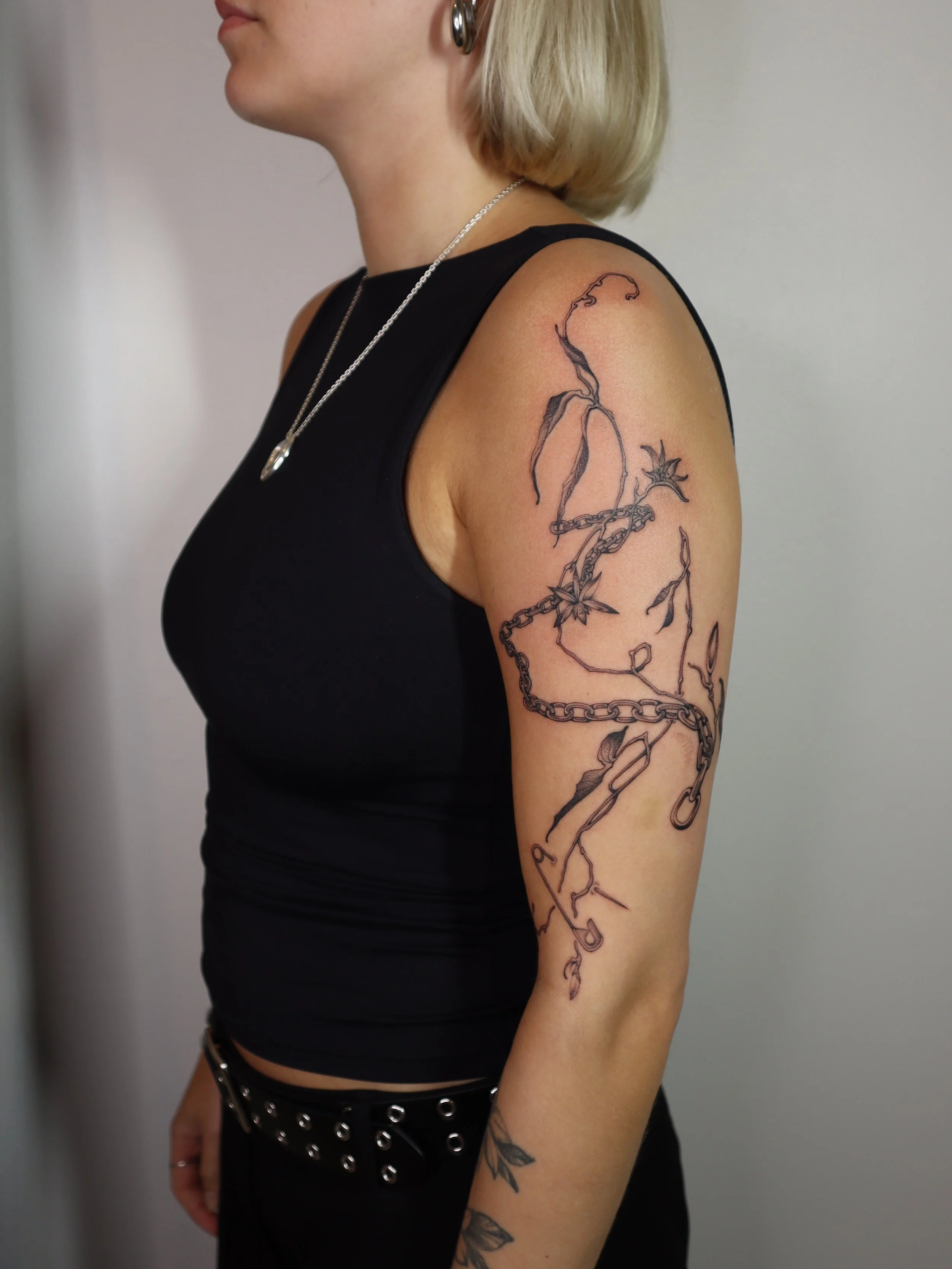 Half sleeve floral tattoo with chains Helsinki