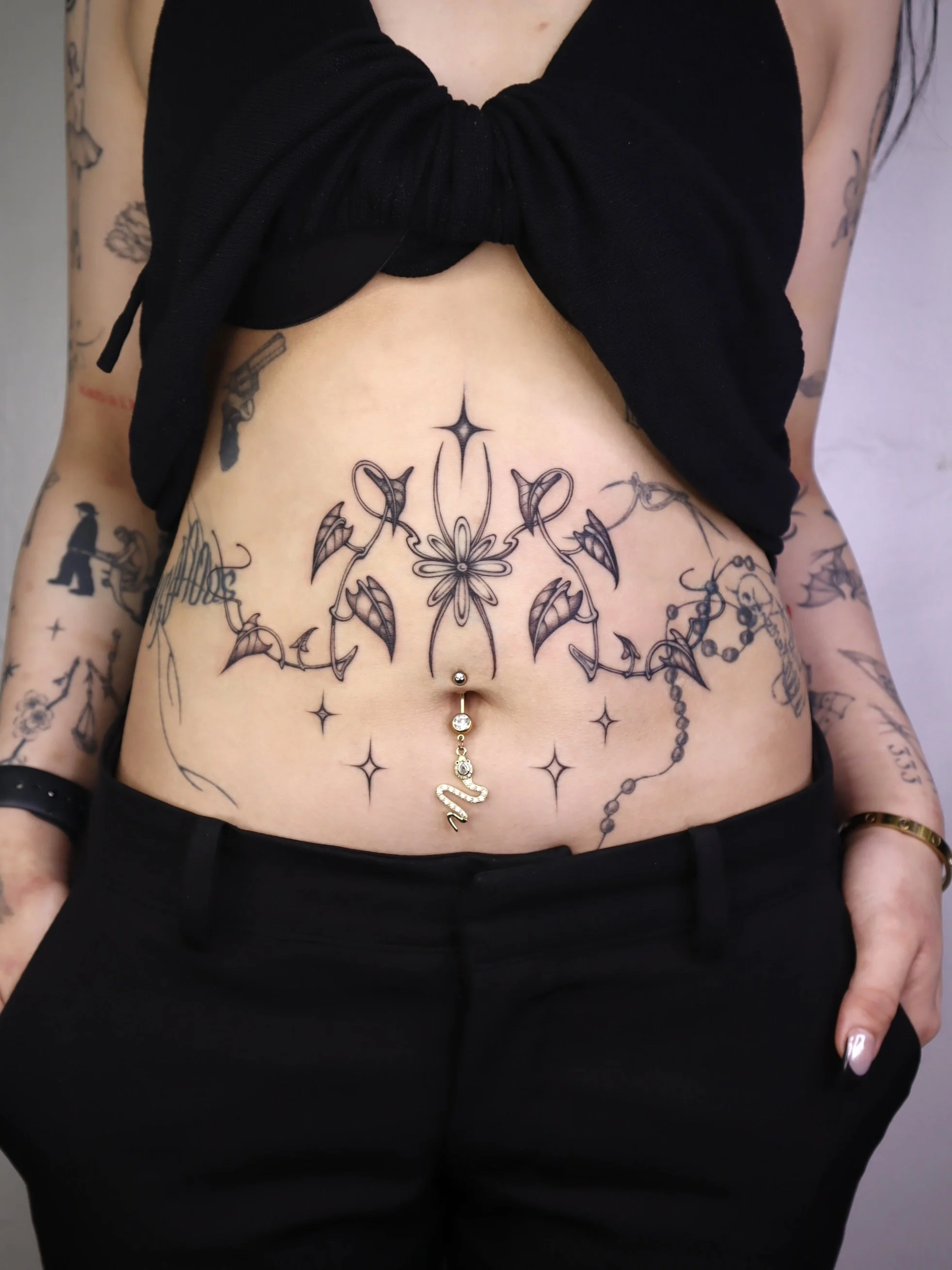 Fine line floral stomach tattoo Helsinki