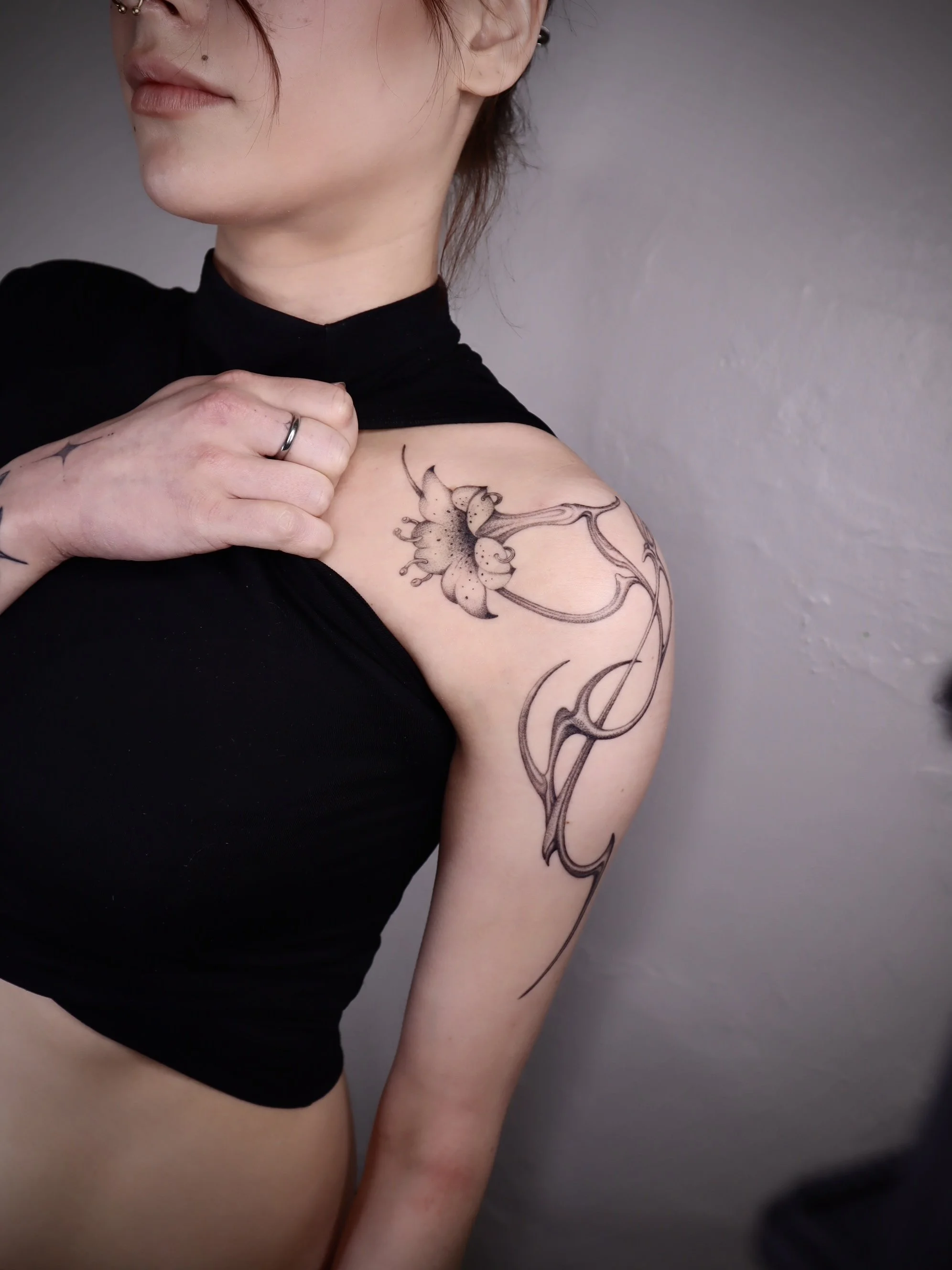 Abstract pierced flower tattoo Helsinki