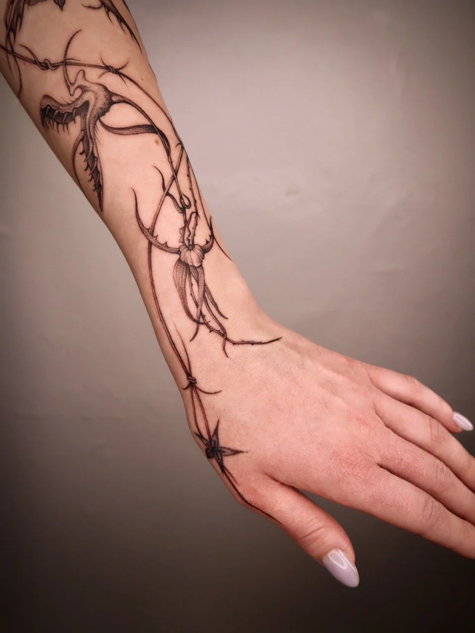 Floral fine line hand tattoo Helsinki