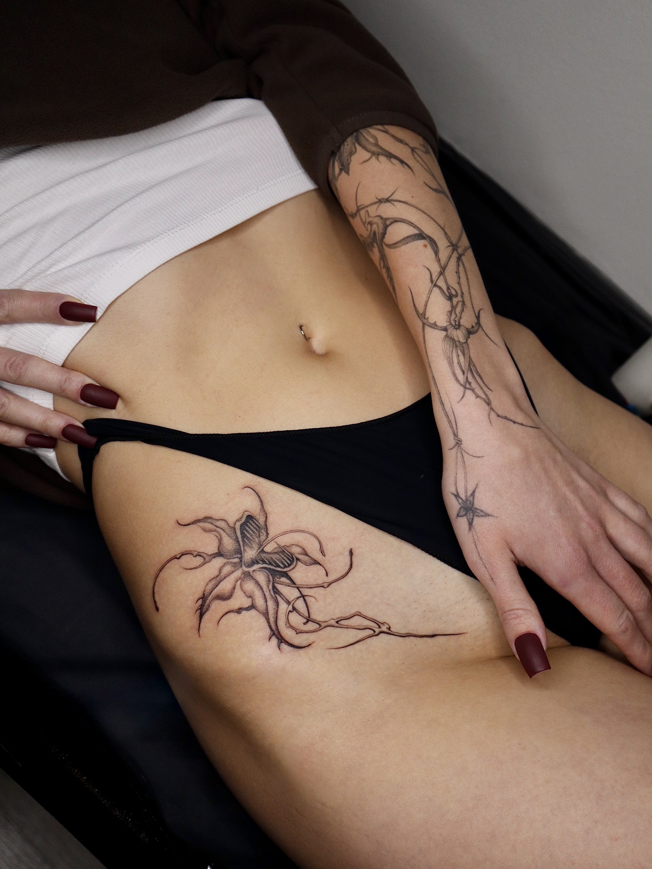 Custom fine line floral tattoo by Helsinki tattoo artist Sister Serpent