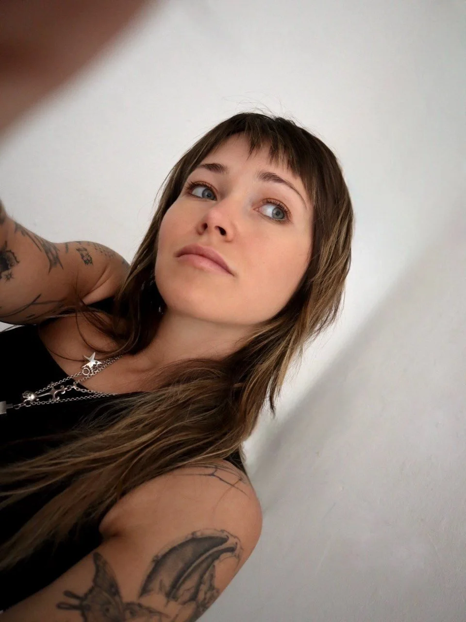Portrait of Helsinki tattoo artist Sister Serpent specialising in fine line and neo-tribal tattoos.