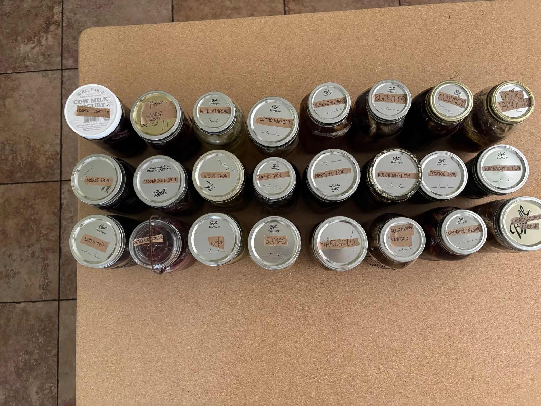 24 jars with different dyes, each labelled neatly.