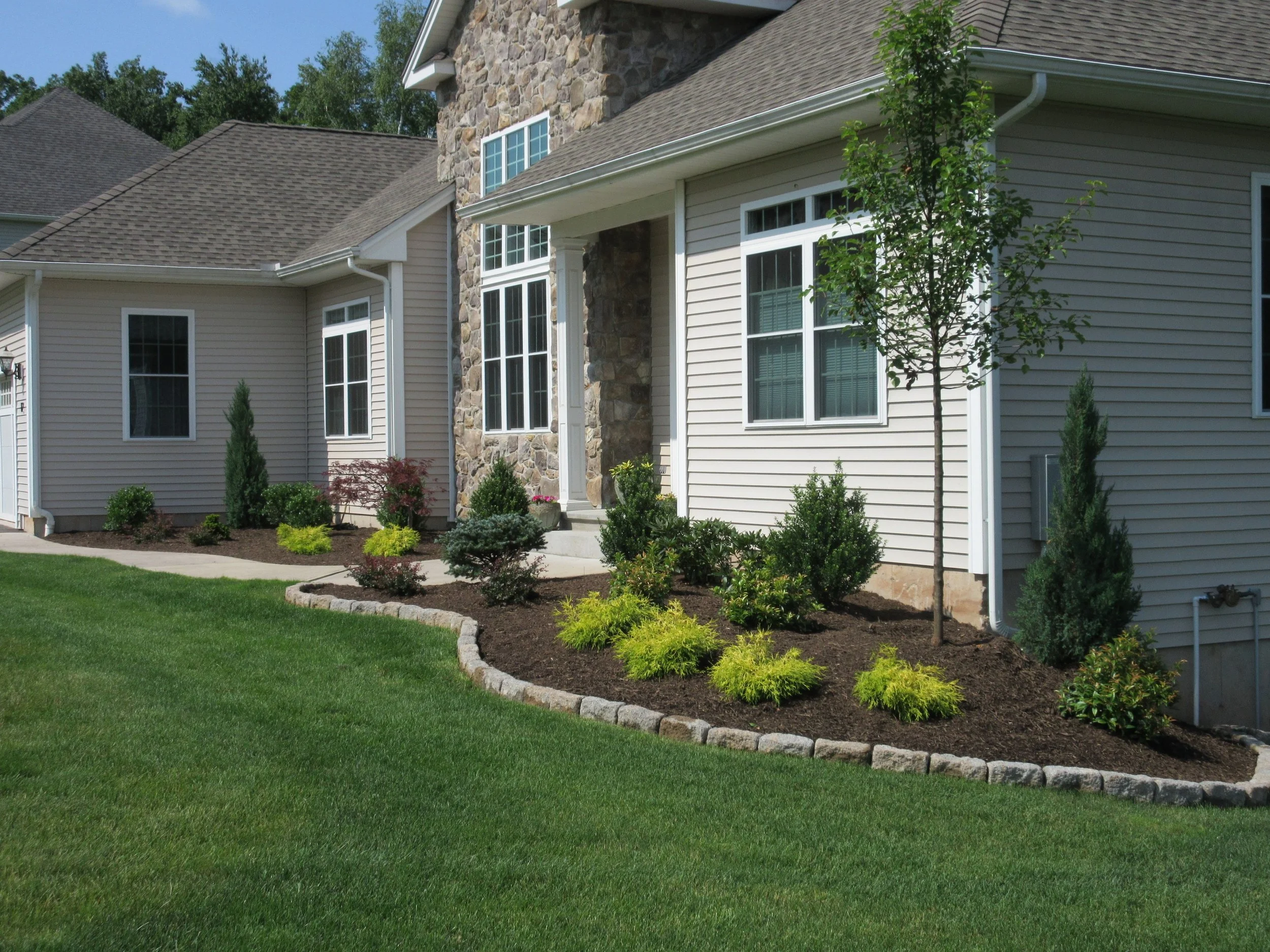 4 Ways Lawn Care Services Keep Glastonbury, CT Landscape Designs Looking New
