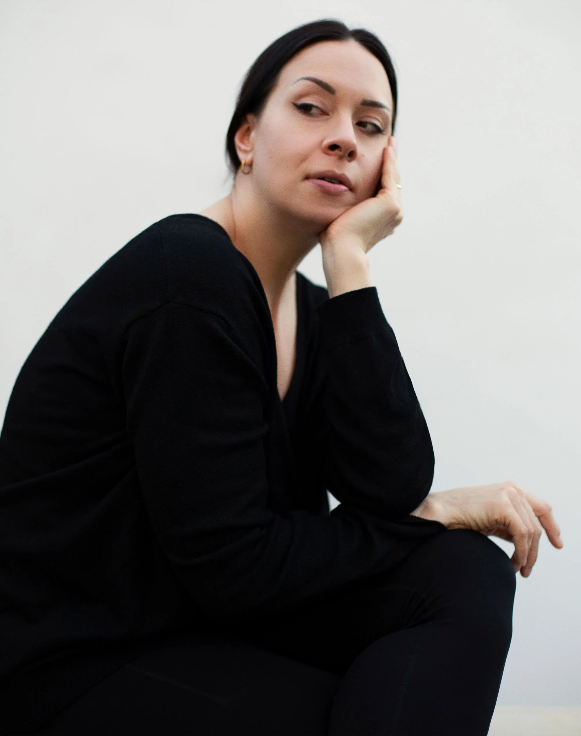 Portrait of contemporary abstract painter Hanne in a quiet studio setting, photographed in natural light.