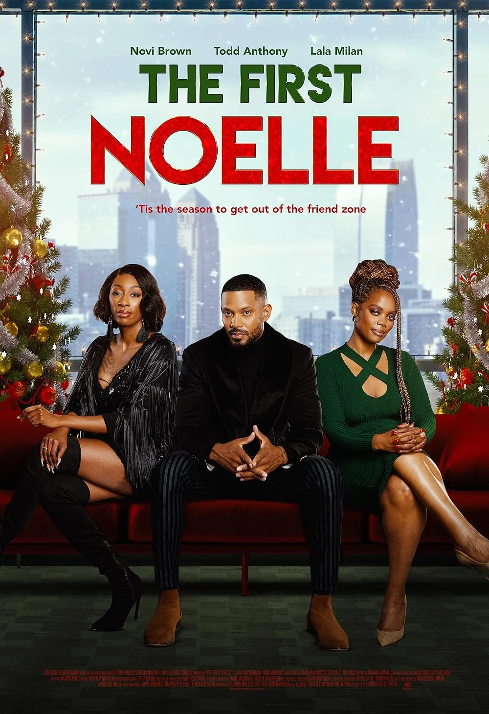 Poster for the film 'The First Noelle' featuring three people sitting on a red couch in front of a window with a city skyline. Two women are on either side of a man. The woman on the left has dark hair and is wearing a black dress with fringes, and the woman on the right has braided hair and is wearing a green dress. There are decorated Christmas trees on each side of the poster background.