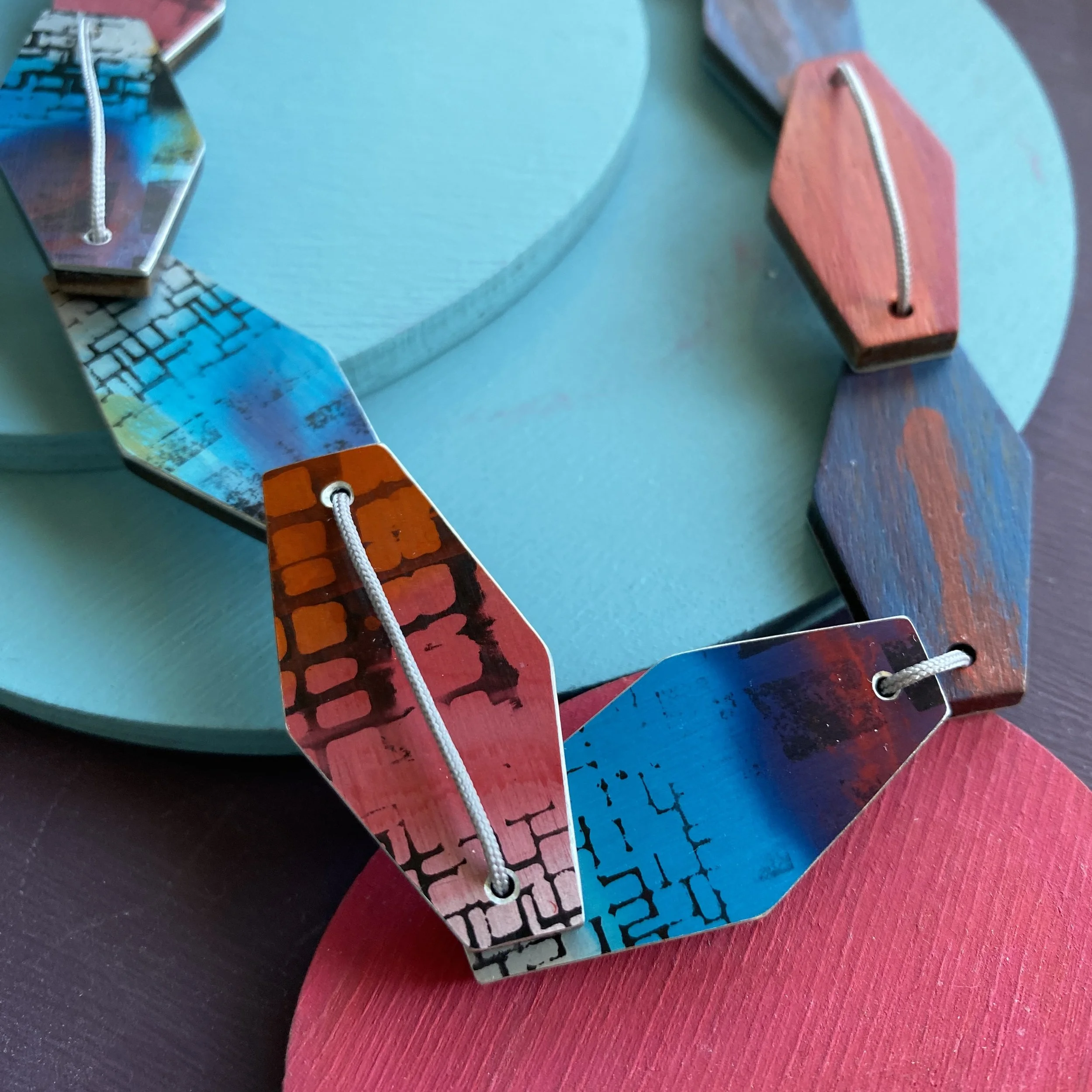 Blue/pink hexagonal 9 piece aluminium & walnut necklace.