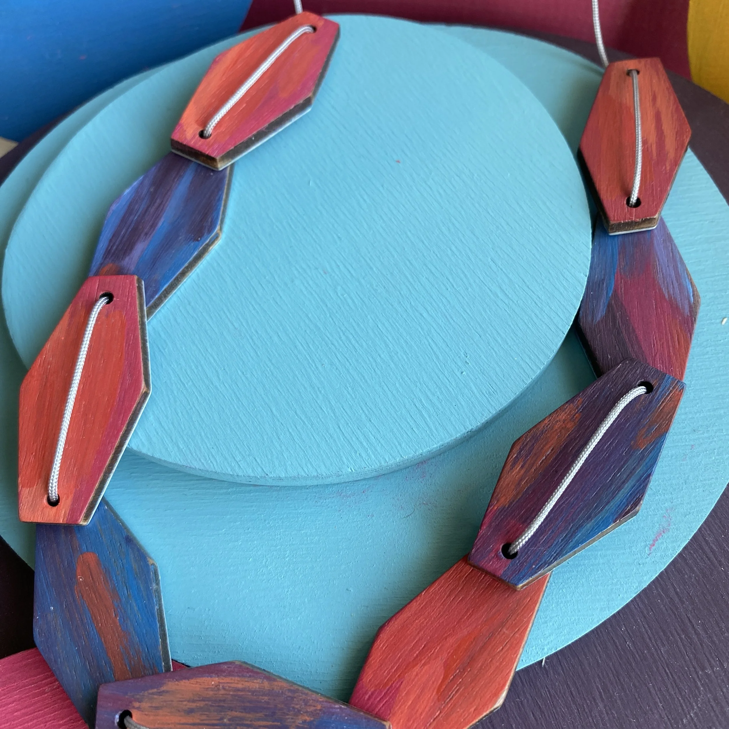 Blue/pink hexagonal 9 piece aluminium & walnut necklace.