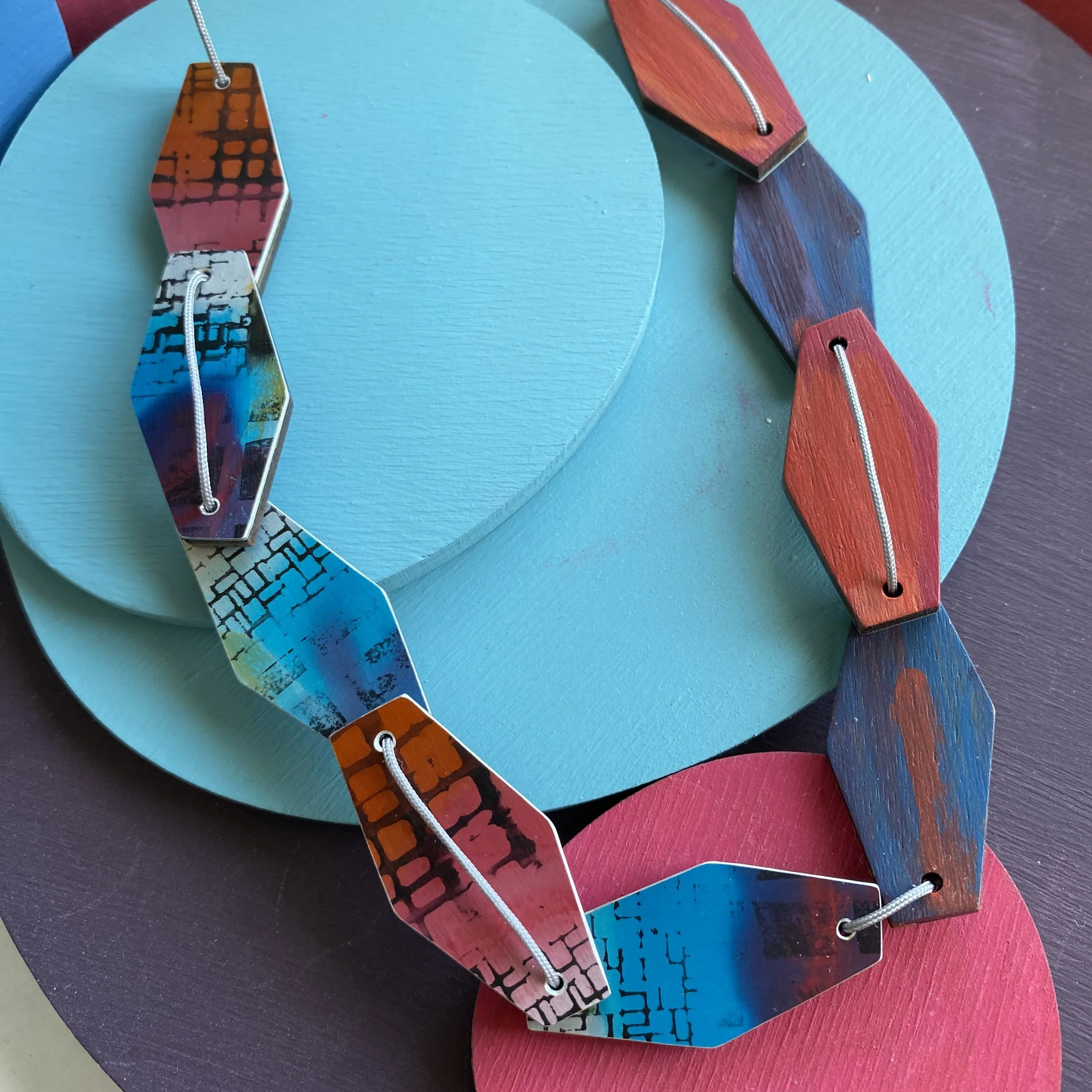 Blue/pink hexagonal 9 piece aluminium & walnut necklace.