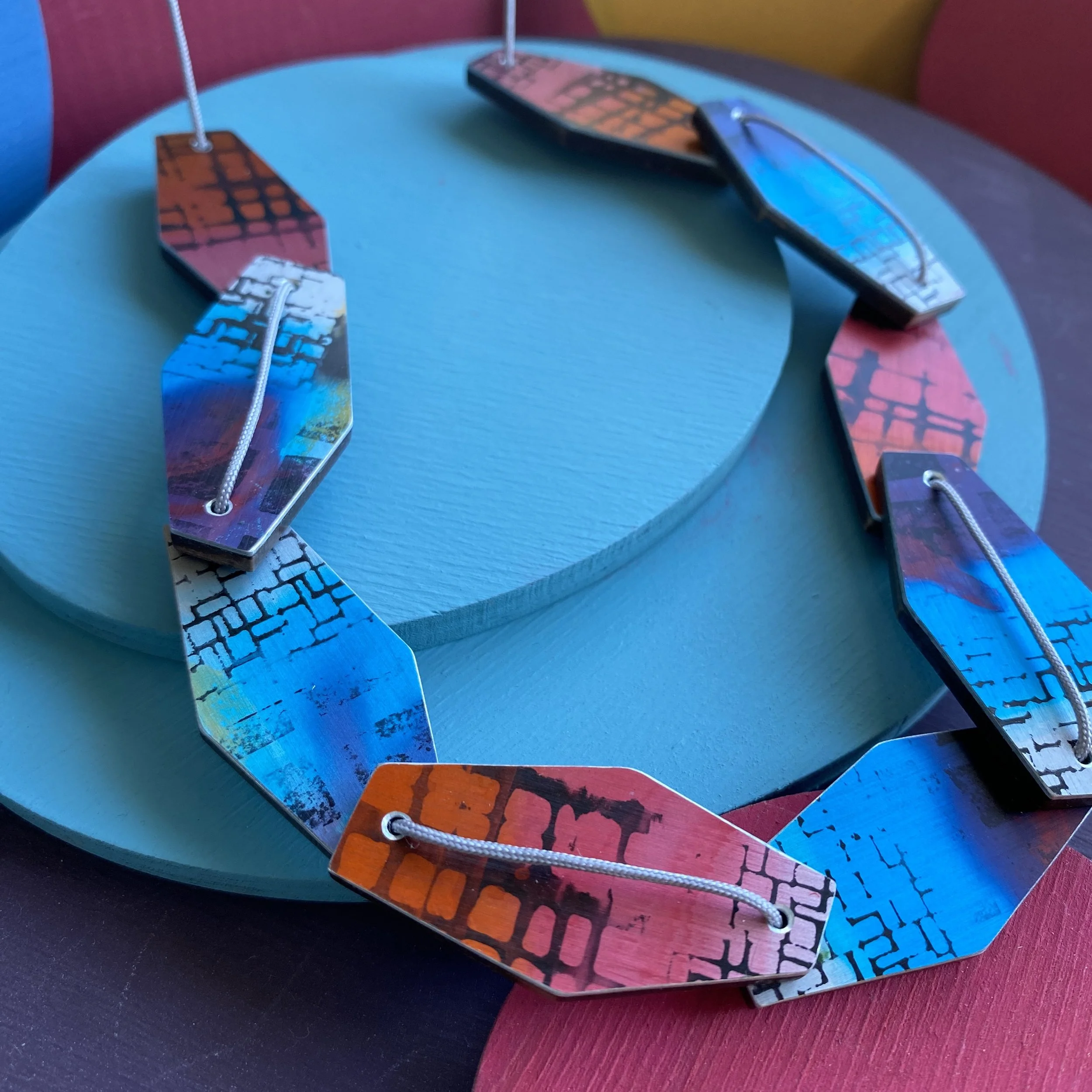 Blue/pink hexagonal 9 piece aluminium & walnut necklace.