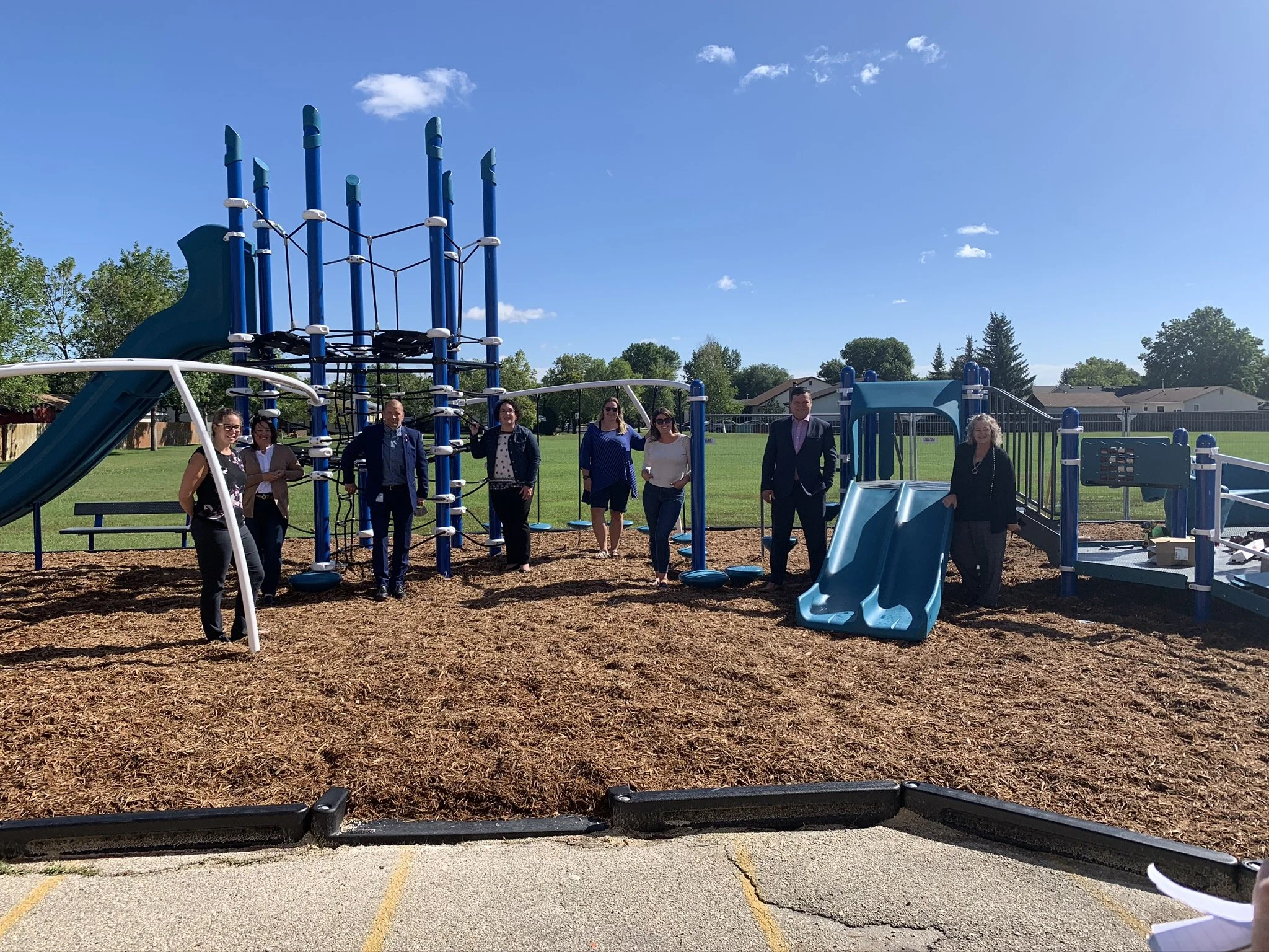 Nason posing with others during a park dedication