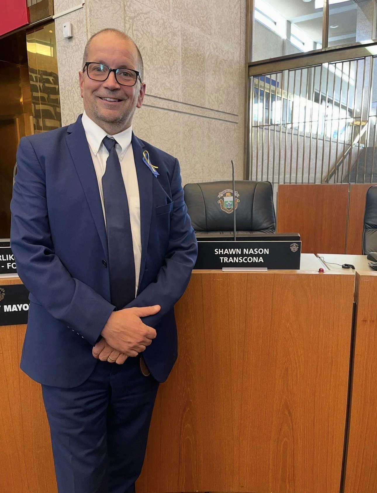 Shawn Nason appearing infront of his name plate in Council  Chambers