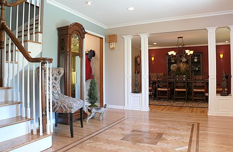 wood floor inlay design with herringbone layout and wood panel columns