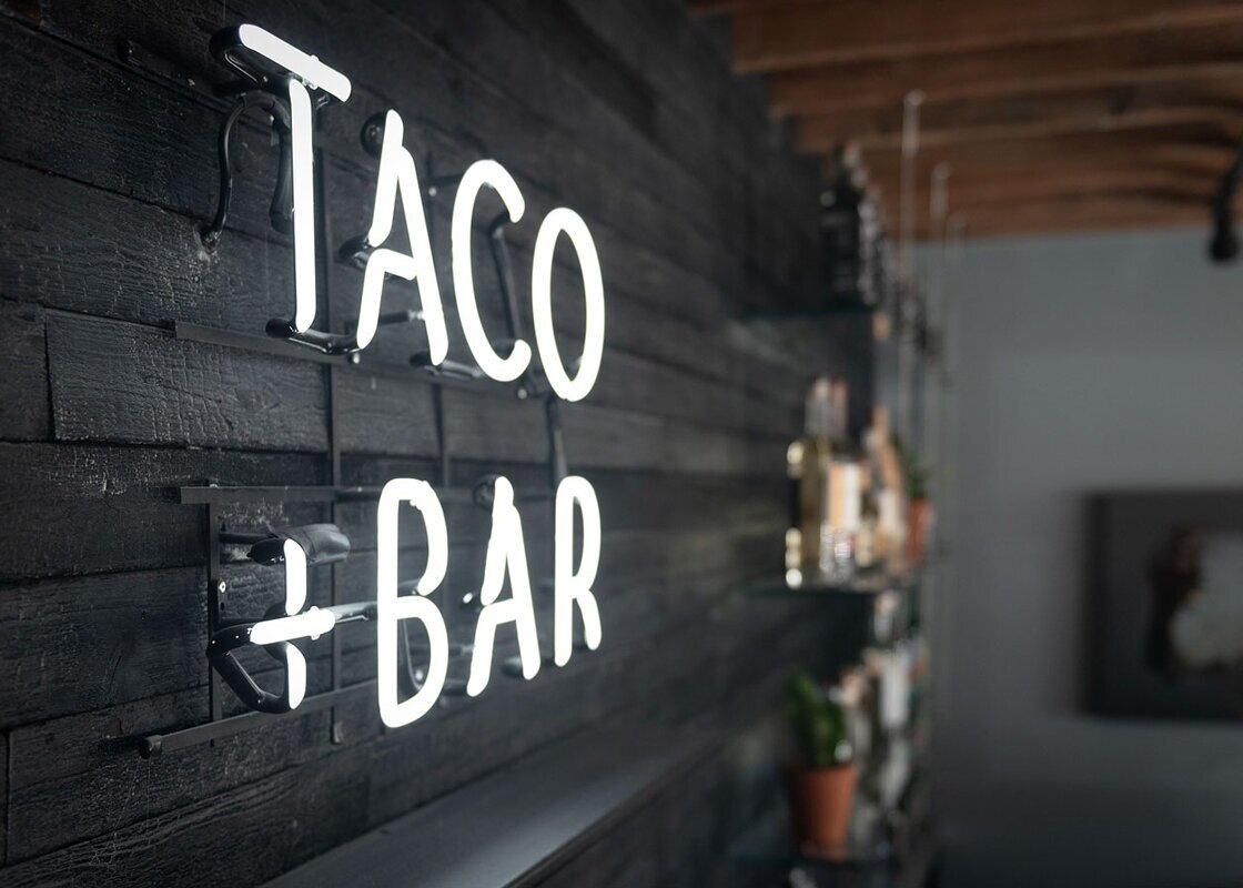 TACO + BAR This community cantina is an adaptive reuse of a 100-year old structure. Once a neighborhood market and more recently a beer/wine convenience store.