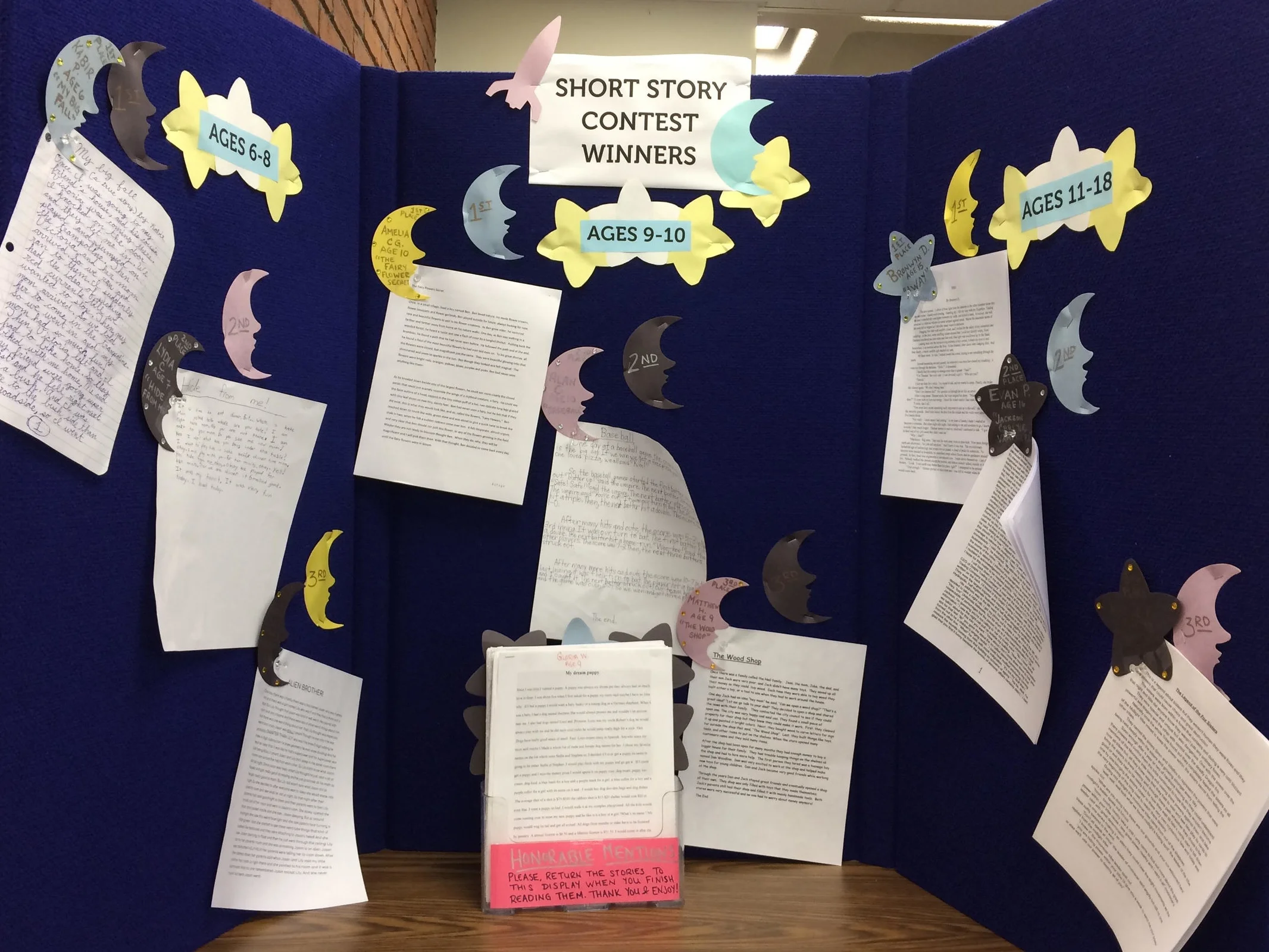 Board with short story contest winners and honorable mentions.