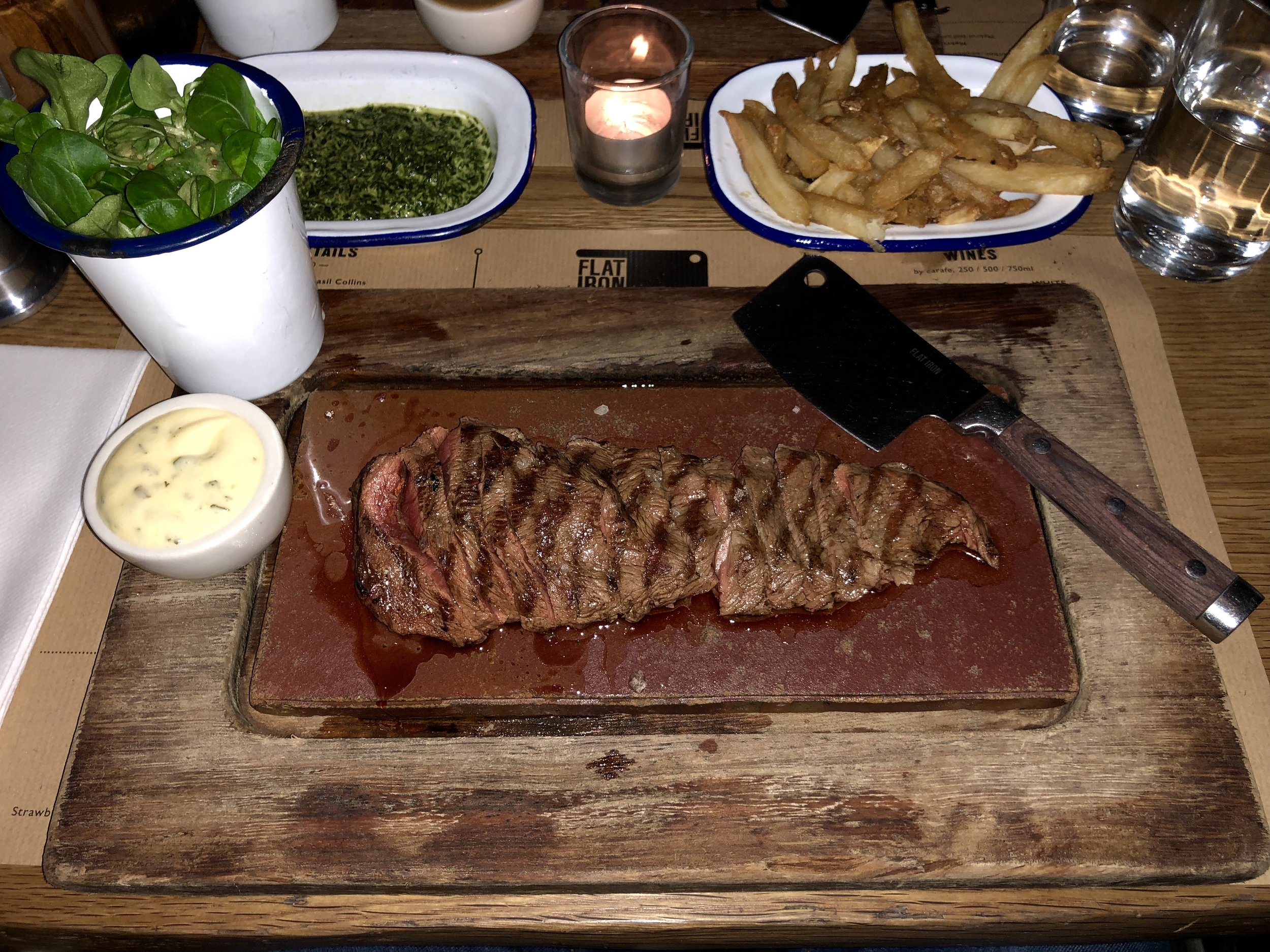 Steak and fries with salad at Flat Iron in London
