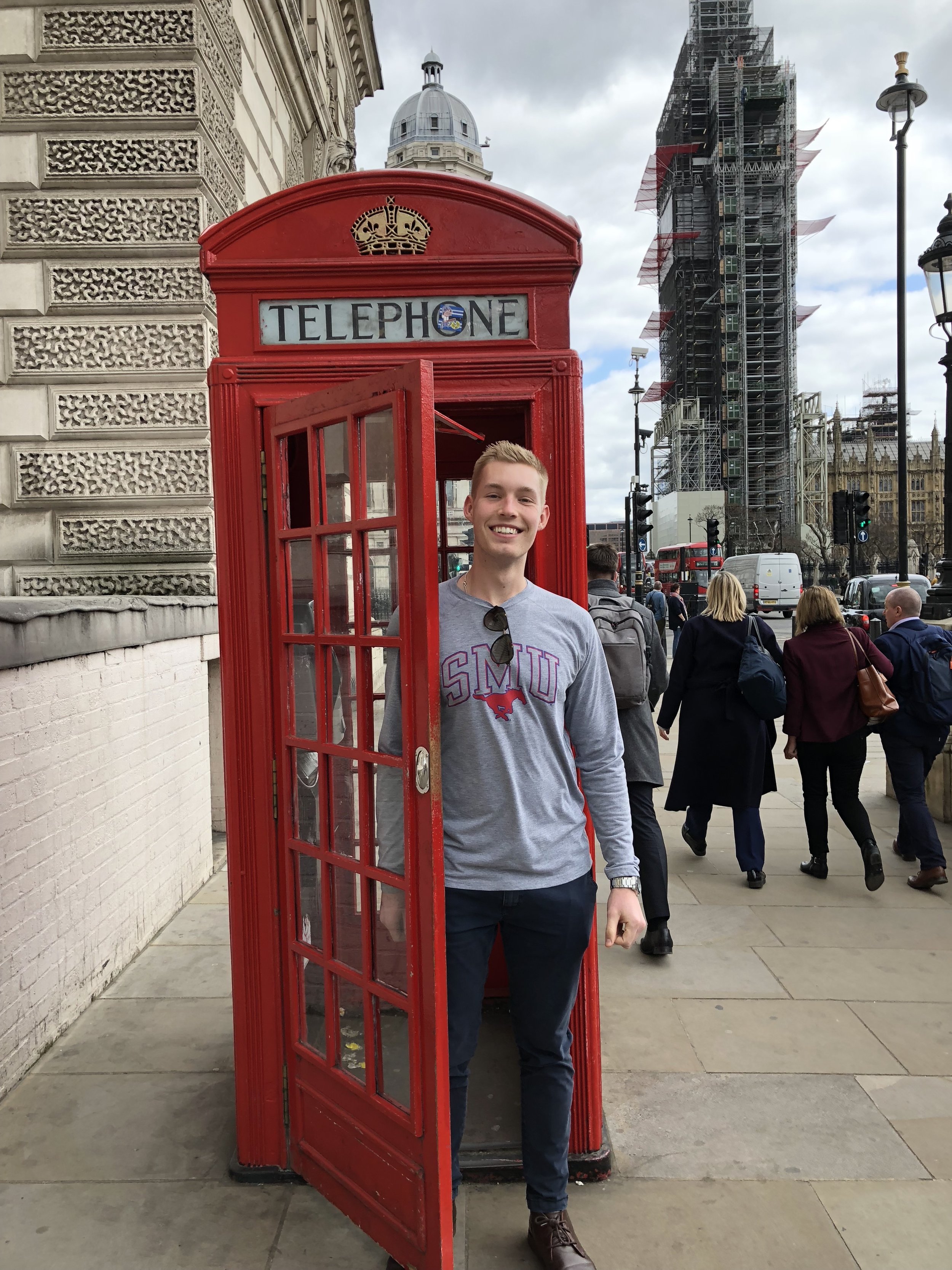 Adam in front of telephone booth in London, Big Ben in the background