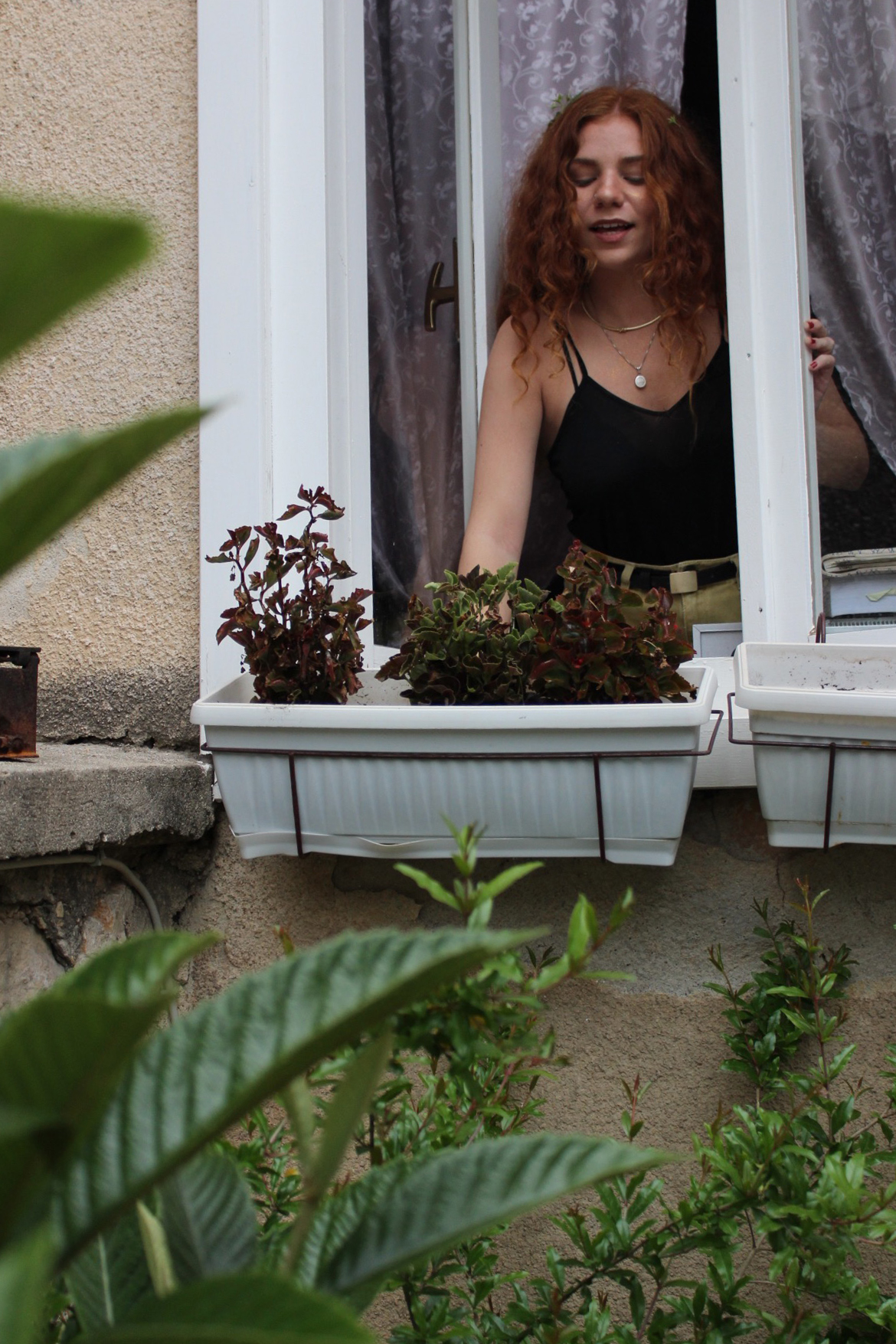 Olivia Soyk waters the plants in the Bosnian hostel where she works. Soyk found the job on the website Workaway, where backpackers trade their skills for a place to sleep and food while travelling.