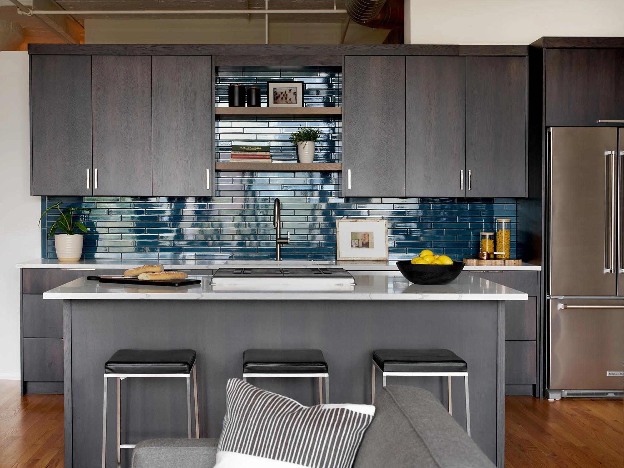 Modern Loft Kitchen: dark cabinets, deep watery blue backsplash.