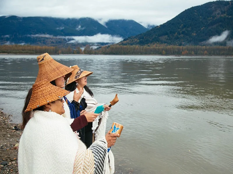 Members of the Tulalip Tribe sing along the banks of the Fraser River in Chilliwack, British Columbia, as part of a ceremony to honor the waters and marine life so integral to the Coast Salish way of life. Chris Jordan-Bloch / Earthjustice