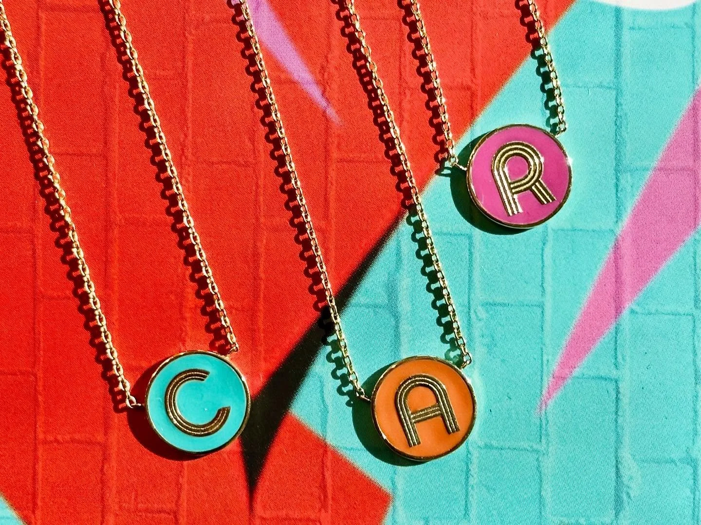For the monogram muse- our art deco mini letters come on a delicate rolo chain which can be worn at 2 lengths. ✨Choose your letter and your enamel color- and we mean ANY color!!! Just dare us to match your Pantone preference!! 🌈