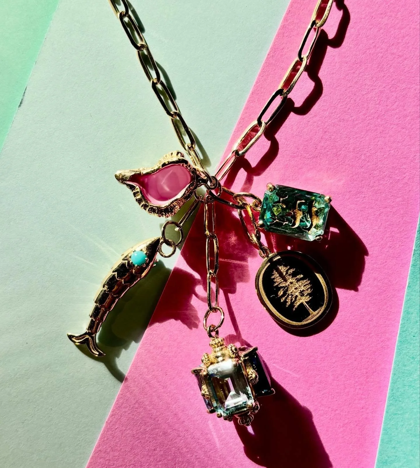 A perfect combination of family and passions on our handmade Madison chain. 🩵 3 stone Fob, fish with turquoise eyes, hand painted conch shell, vintage zodiac and a custom tree charm to celebrate their favorite resort town. 🩵