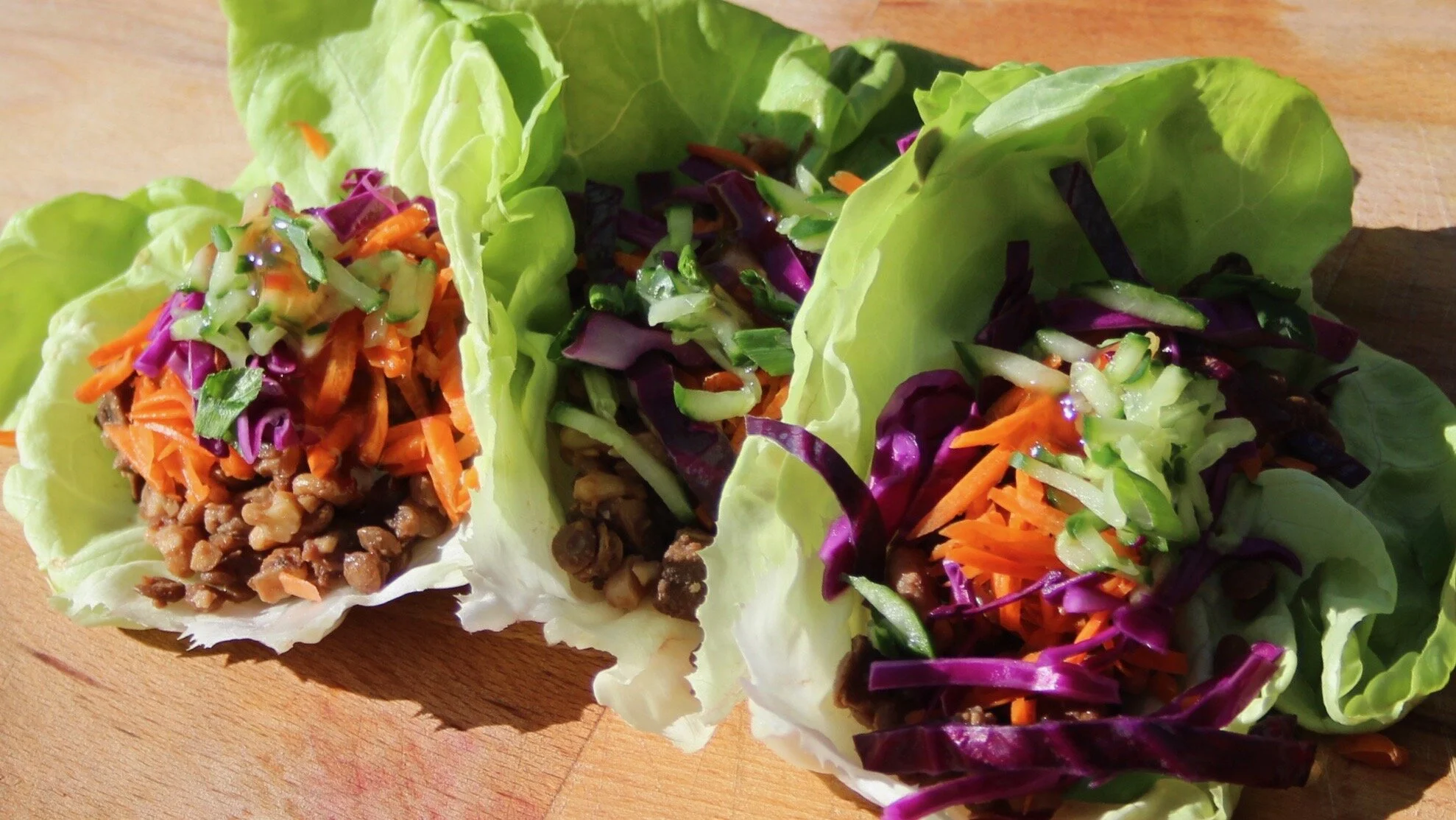 Lettuce Crunch Wraps with carrot, cucumber, and radish topping and sweet thai chili sauce!