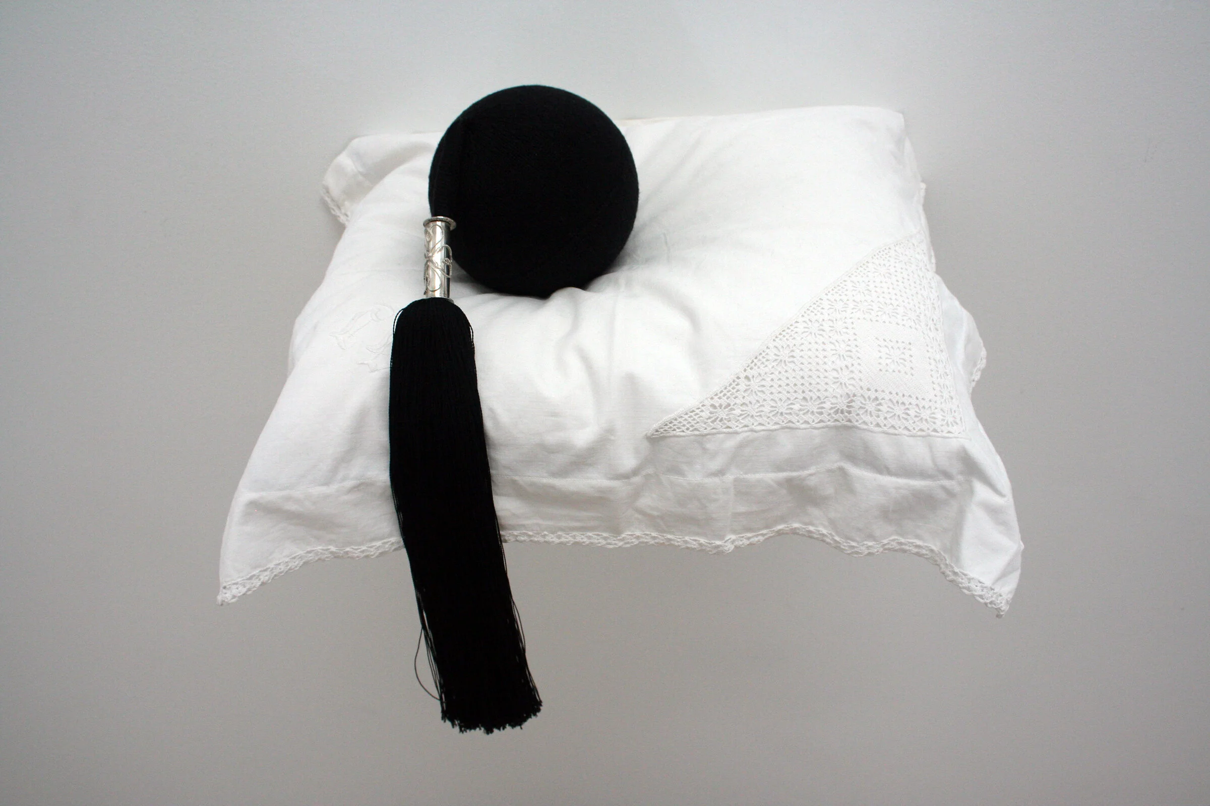 Bombshell / Skotthúfubomba - sculpture, yarn, silver, laced pillowcase, wooden shelf, The Icelandic Folk and Outsider Art Museum / Safnasafnið, Eyjaförður, Iceland, 2008. Private collection. 