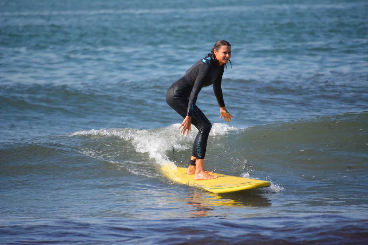 Depicted here is Karen’s first time surfing post surgeries!