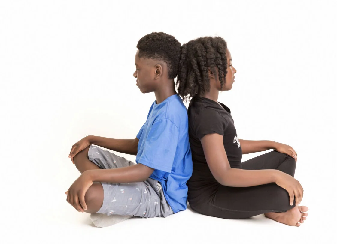 An example of Yogic Breath technique - back-to-back breathing among two siblings. Picture provided by Kat.