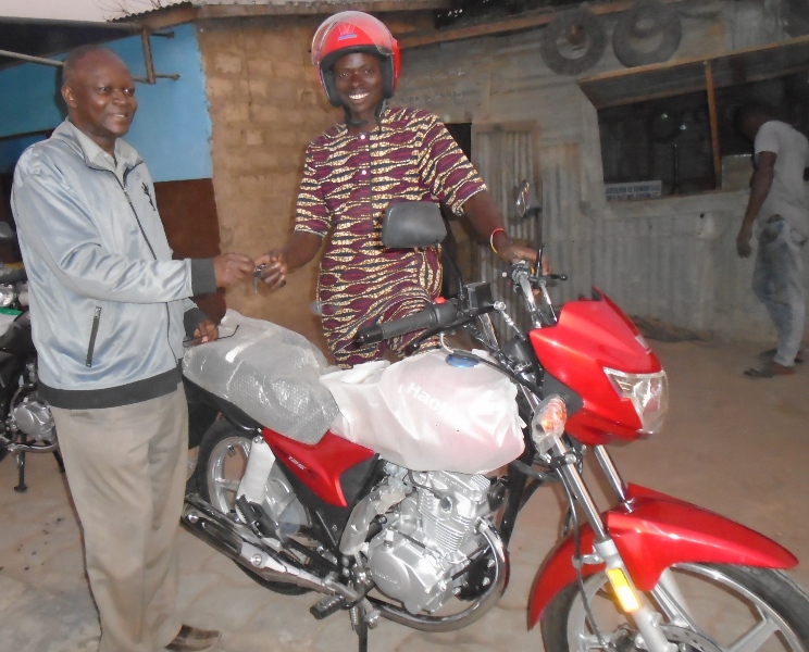 Rev'd Jonathan Adeboye Presenting A  New Motorbike to Pastor Paul Dousounmon.JPG