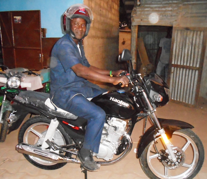 Pastor Saturnine Amadji on His New  Motorbike.JPG