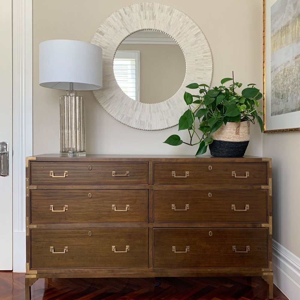 Chest of drawers table lamp and framed art with bone inlay mirror in a home office design by Hue and Space Interior Design