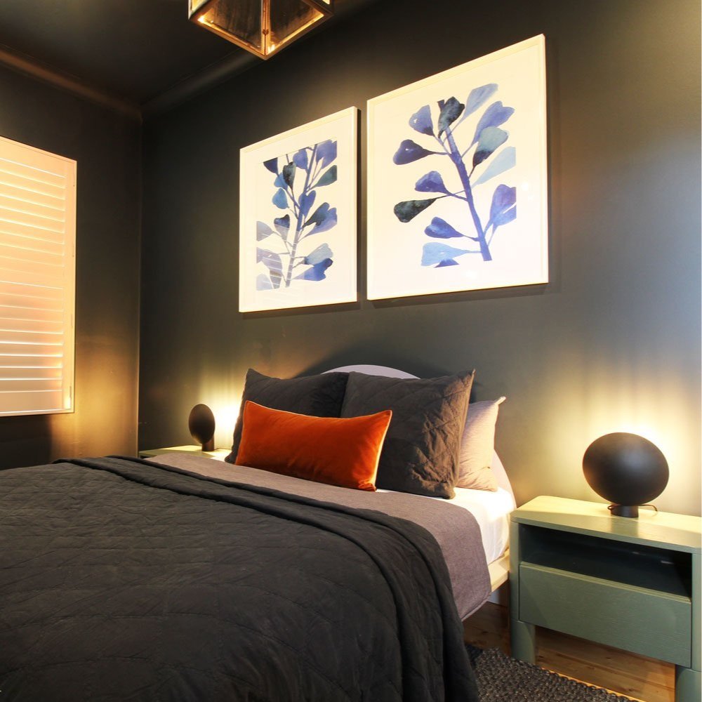 Blue and white framed art over a bed with green side tables and large carriage pendant over a bed, boys bedroom designed by Hue and Space North Melbourne