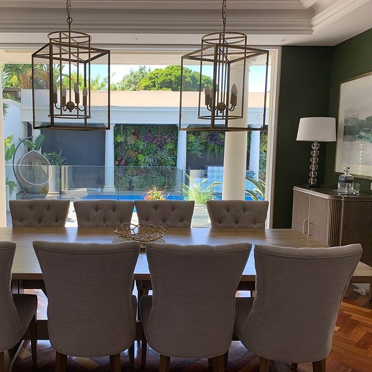 French Provincial dining table and chairs with large scale pendant lights crystal lamp and bronze bar cabinet dining room makeover designed by Hue and Space Interior Design