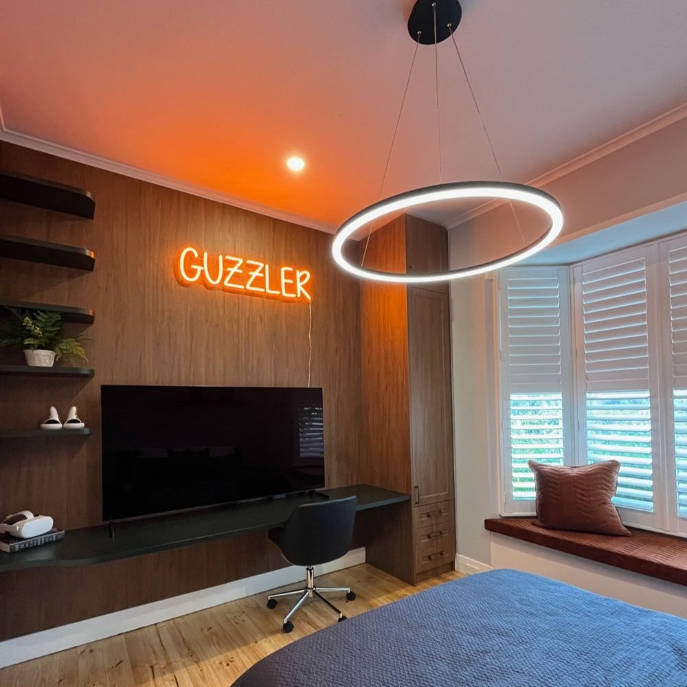 Teenage boys bedroom with custom neon sign and custom joinery designed by Hue and Space Interior Design