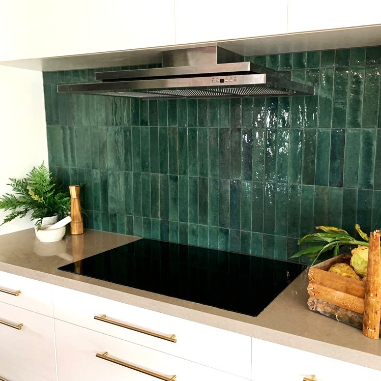 Close-up of handmade green subway tile placed vertically to add interest in this kitchen make-over by Hue and Space Interior Design